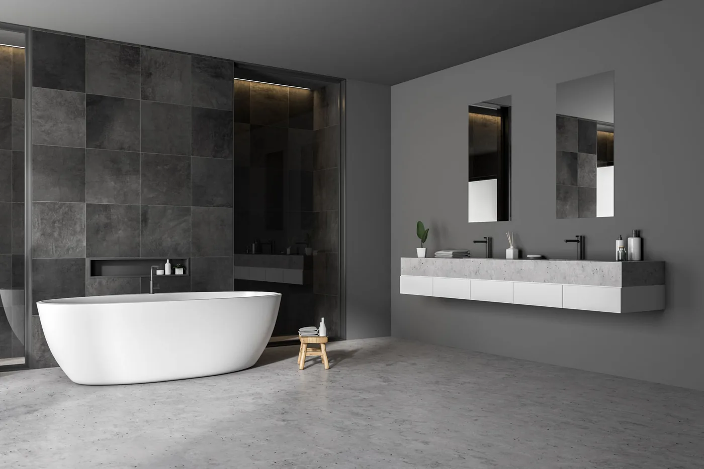 Grey stone tiled bathroom with a floating double vanity and freestanding oval bath