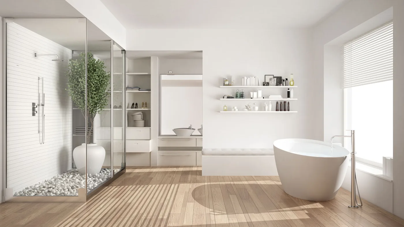 White ensuite with a pebble floor shower, timber floor and freestanding bath